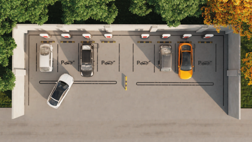 Projektillustration PVmCharge: Luftaufnahme eines Ladeparkplatzes mit mehreren Fahrzeugen und Ladesäulen