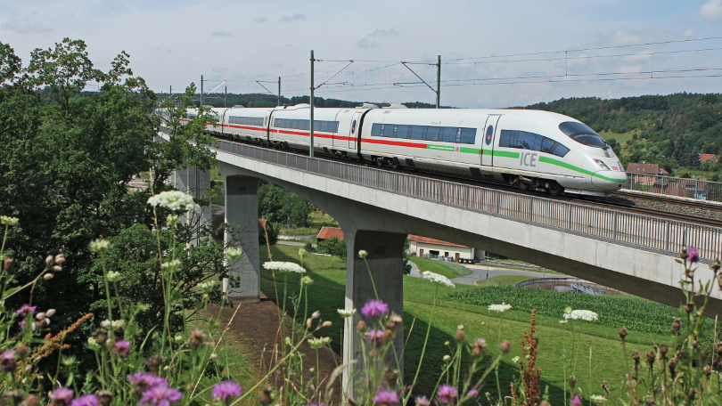 An ICE 3 of the 403 class is crossing the Aurach river near Emskirchen