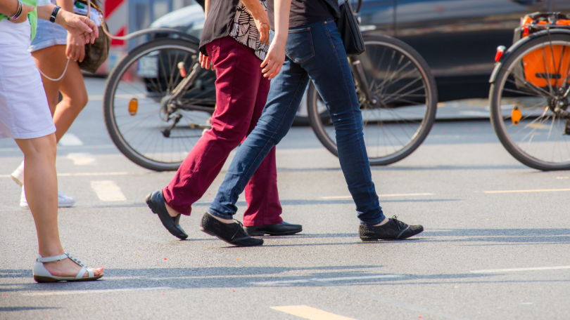 Several pedestrians are crossing a street