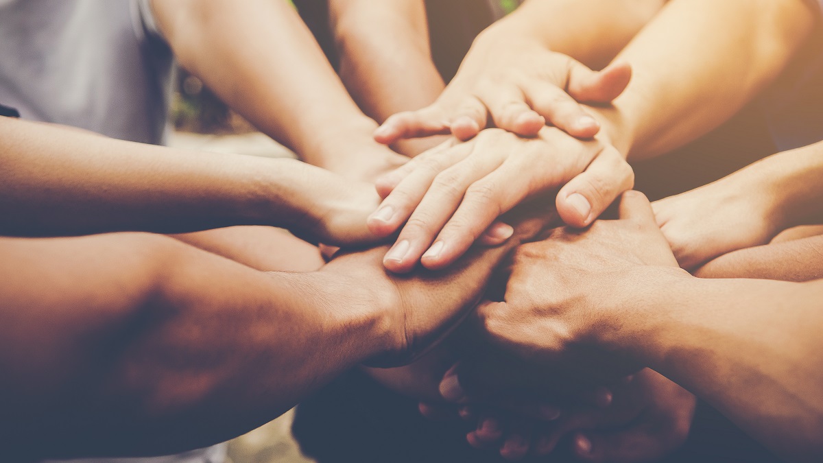 Several People putting their hands together